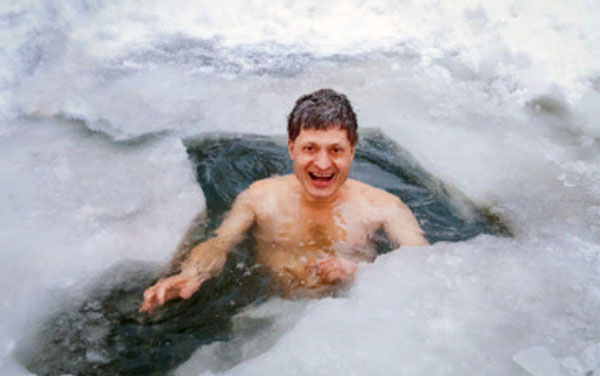 Счастливый мужчина сидит в ледянной воде